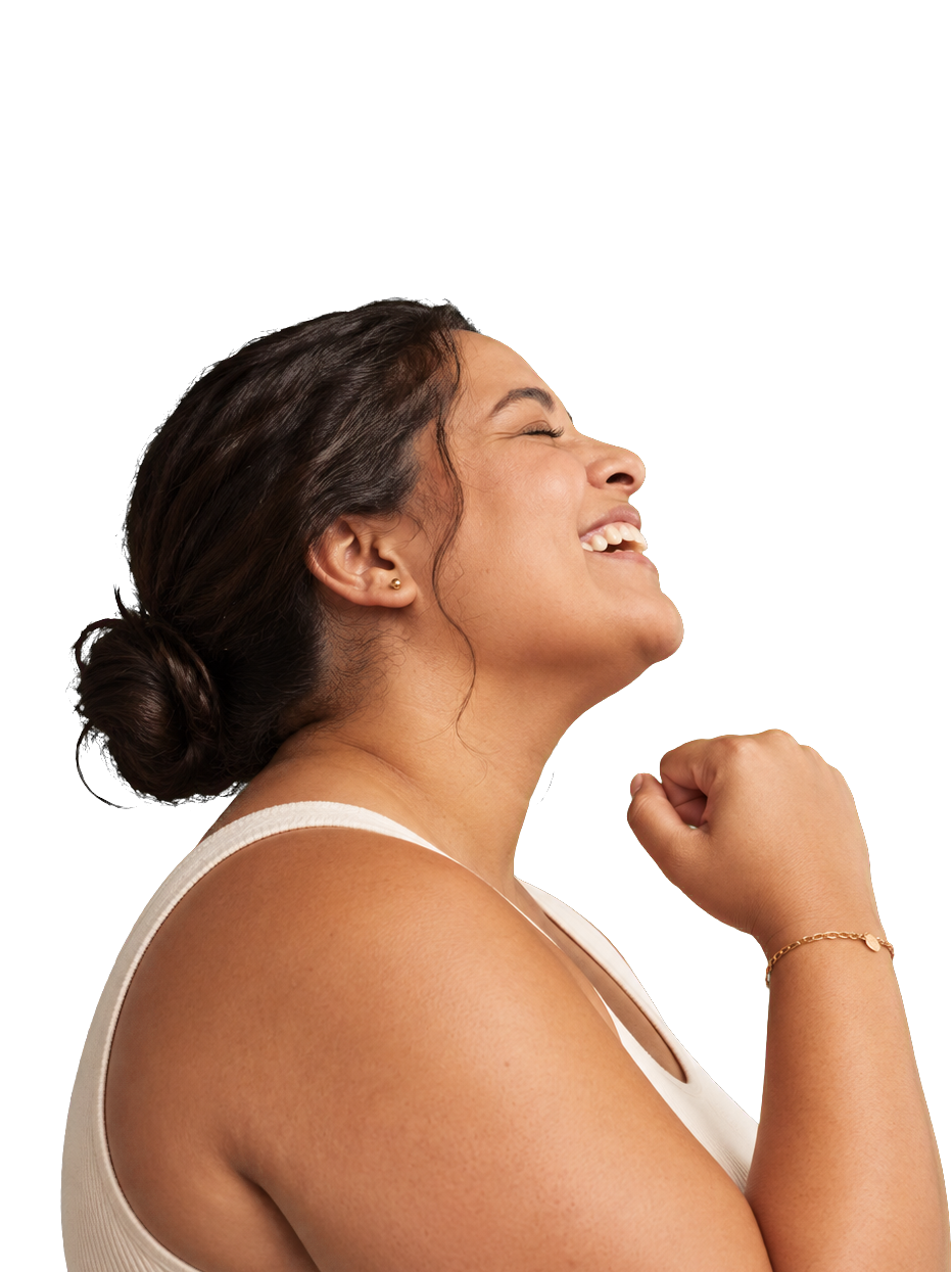 A woman laughing with her fist raised in celebration