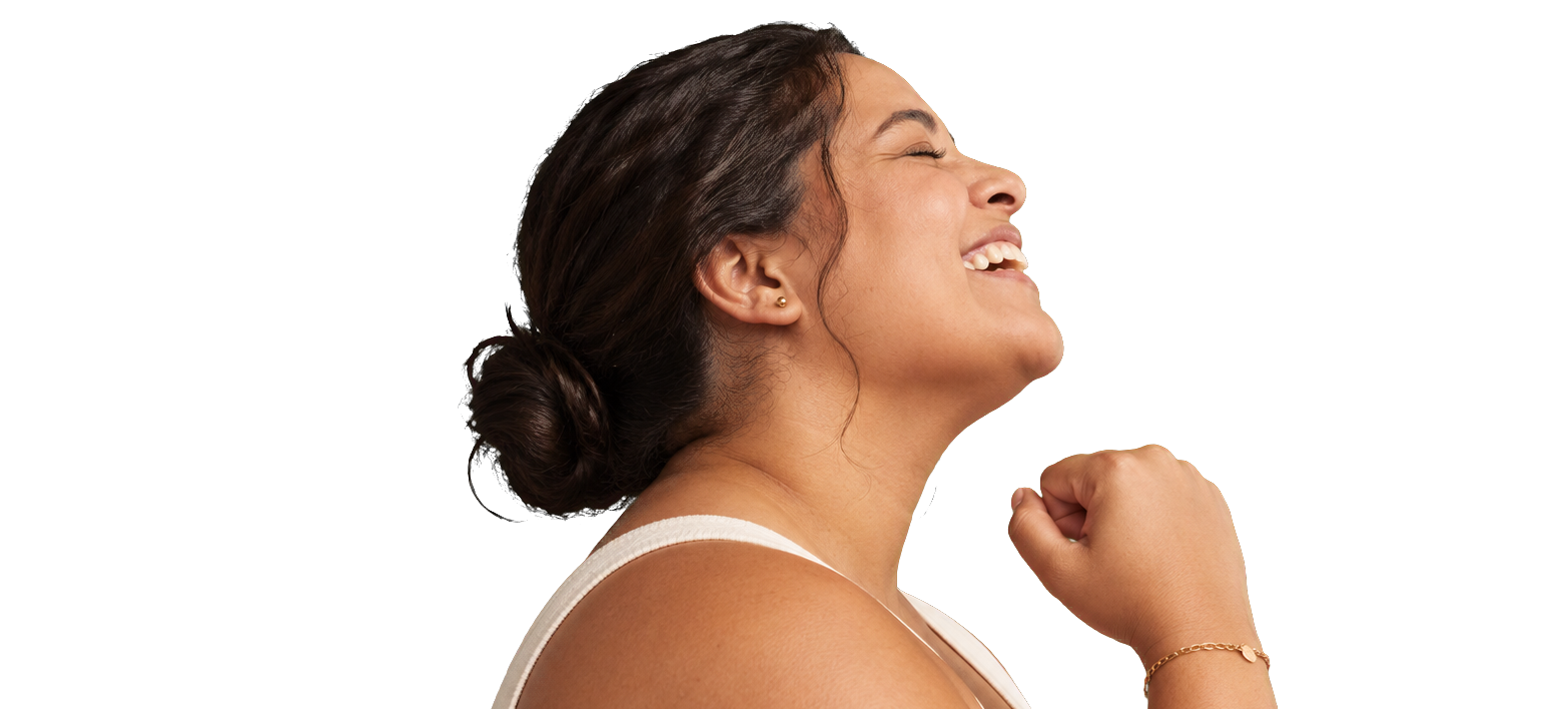 A woman laughing with her fist raised in celebration